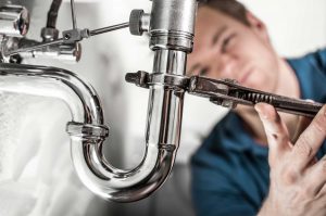 Jim's Plumbing Troubleshooters in Dallas OR- plumber fixing p-trap
